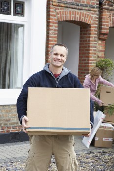Moving truck parked with household items