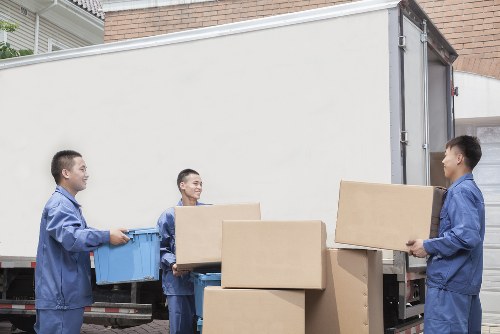 Professional movers handling office equipment in Highbury