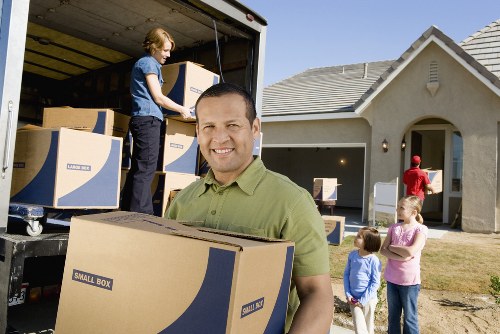 Satisfied customers with their belongings after using Highbury's man and van service