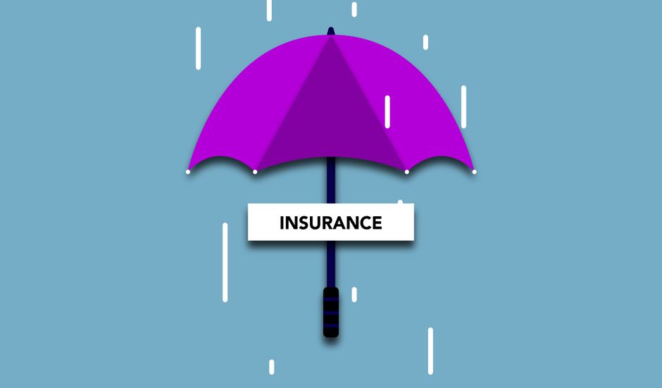 A person wearing a dark suit is seated at a grey wooden table, holding a pen and reviewing a document titled 'Insurance Policy' with detailed text and fields for information. On the table, there is a